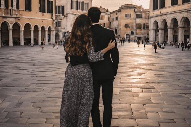 A couples embracing in an Italian piazza.