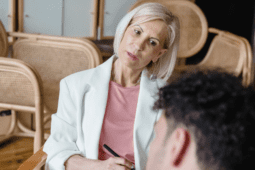 A female therapist sits with her male client looking thoughtful