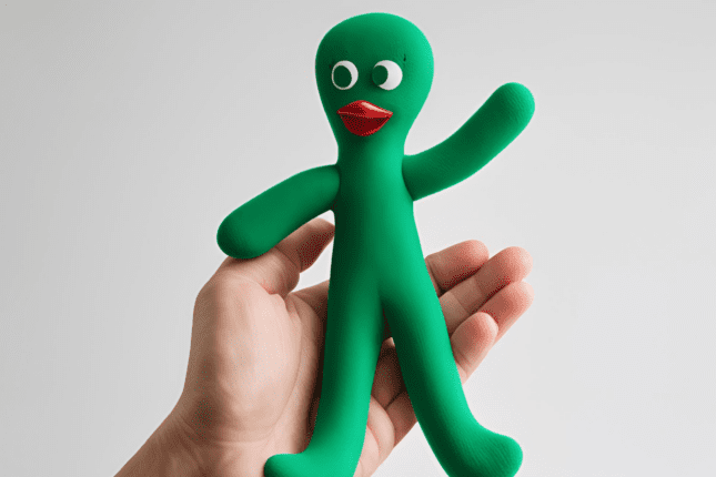 Hand holding Gumby doll