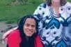 A Black man and a white woman smiling