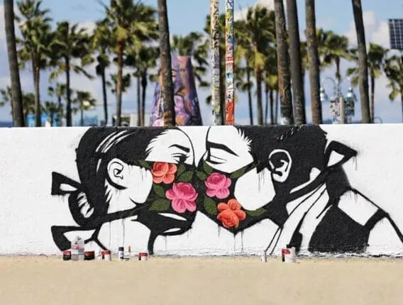 Graffiti of two masked people kissing