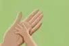 A small hand reaches to touch a larger one
