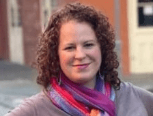 Woman smiling with multicolor scarf around her neck