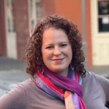 Woman smiling with multicolor scarf around her neck