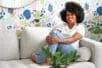 Nedra Glover Tawwab sits on a couch smiling