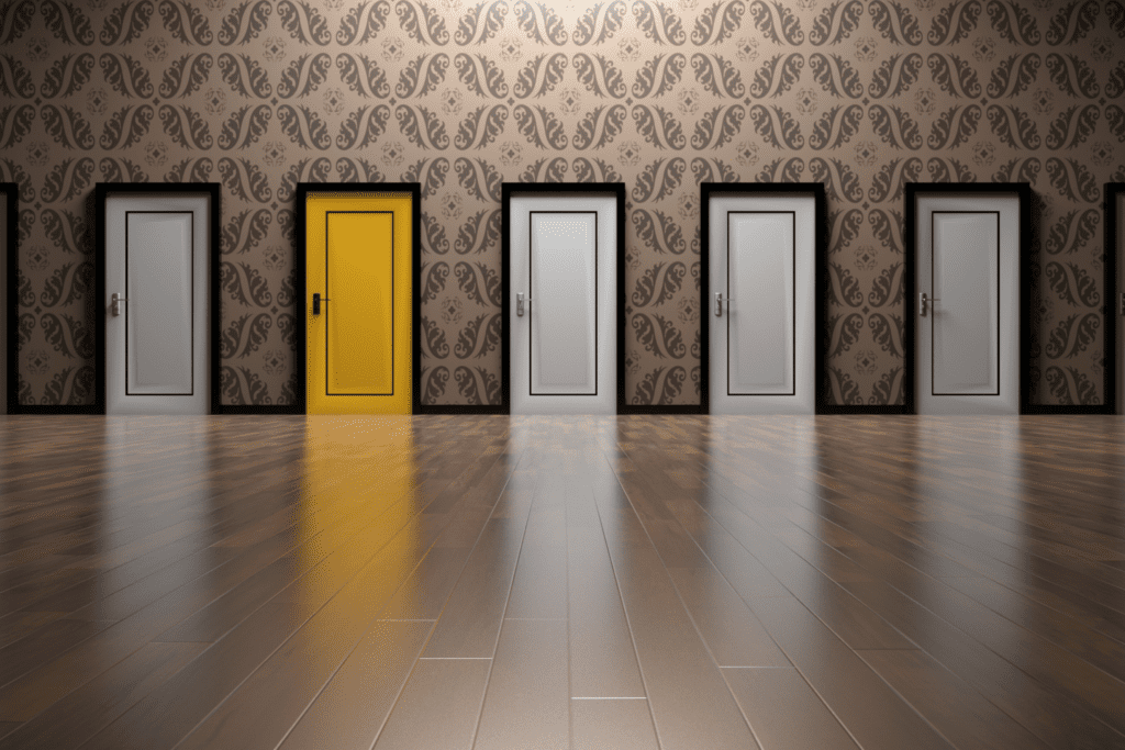 A rows of doors side by side, all in white except for one that is bright yellow