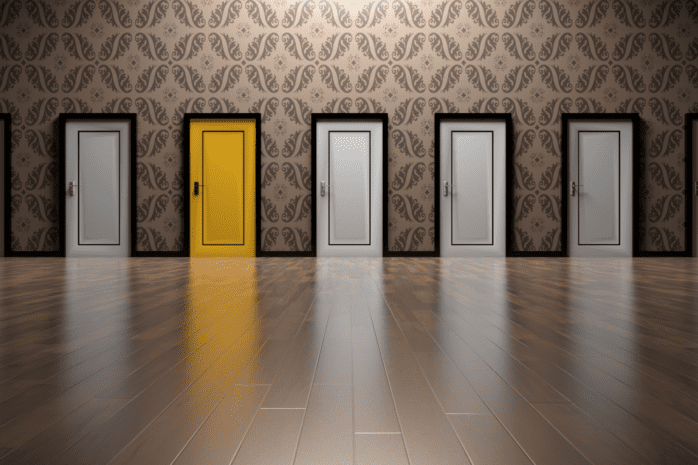 A rows of doors side by side, all in white except for one that is bright yellow