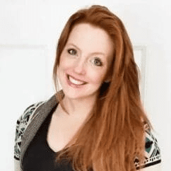 Red-haired woman in sweater smiling