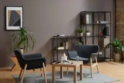 A psychologist office with two gray chairs facing each other