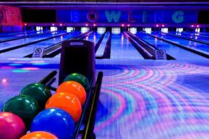 Photo of a bowling alley under dark and colorful lights