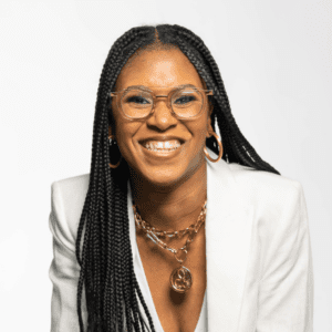 Smiling woman in white suit.