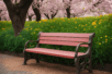 red bench by green flowers and flowering trees