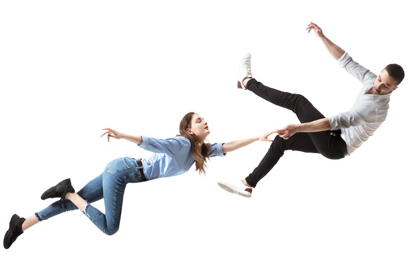 A couple floats and falls through space, reaching for each other