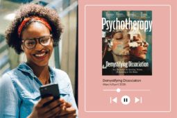 A woman looks at her phone on the left side of the image and smiles while the right side of the image displays the cover of this month's issue with a play button beneath it